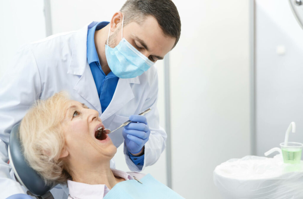 a dentist screens a senuir woman for periodontal disease