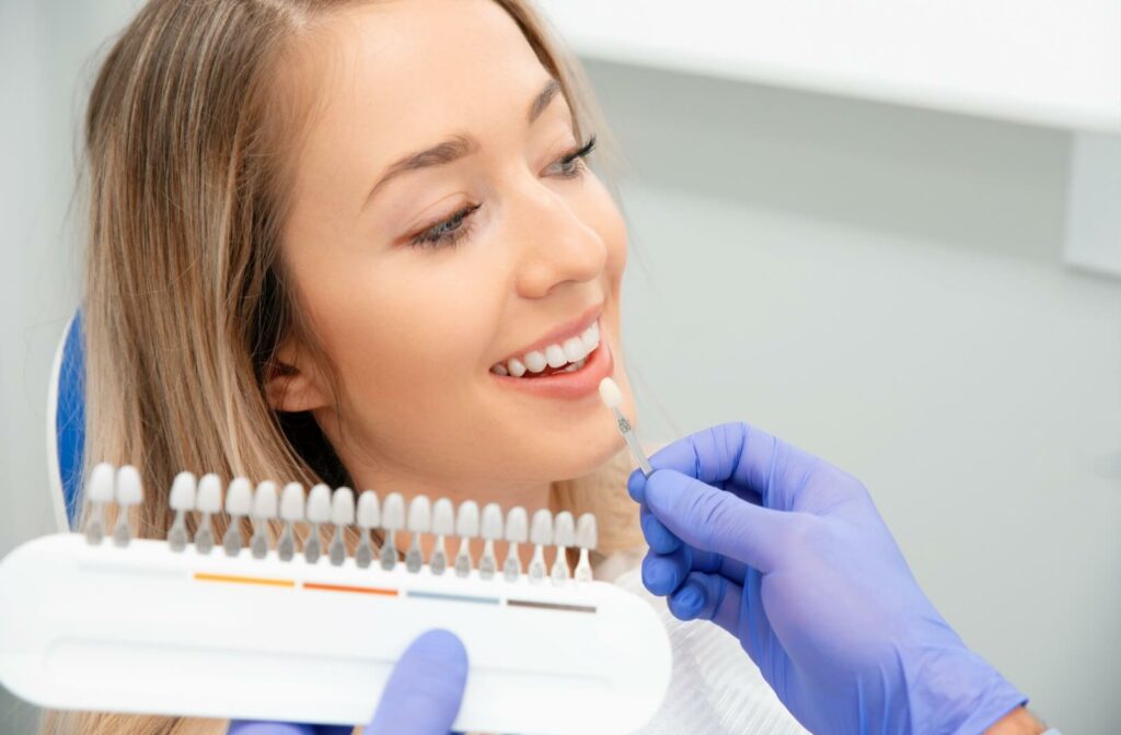 A young woman at her dentist's office discussing teeth whitening.